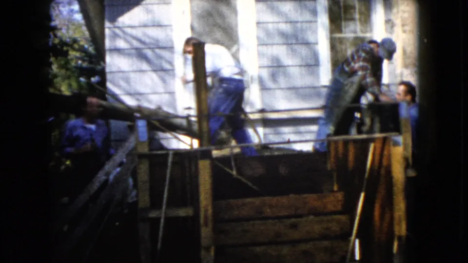 The final frame shows porch repair outside the Wauconda house, with one man near a post and another at the side of the wooden structure.