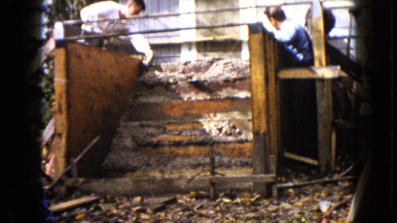 The final frame shows one man reaching over the form and another beside the concrete steps in the 1960 Wauconda home construction scene.