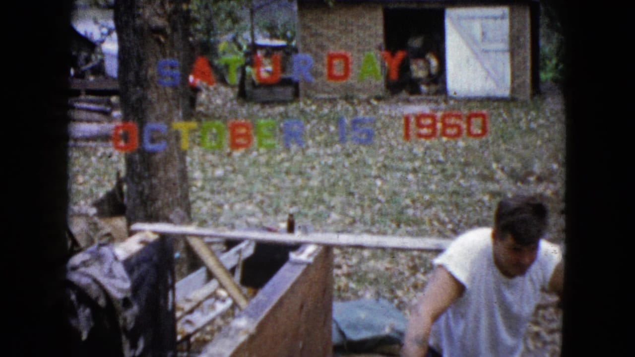 The 1960 home-movie frame shows the man bending at the work area in a Wauconda yard, surrounded by leaves and colored date lettering.