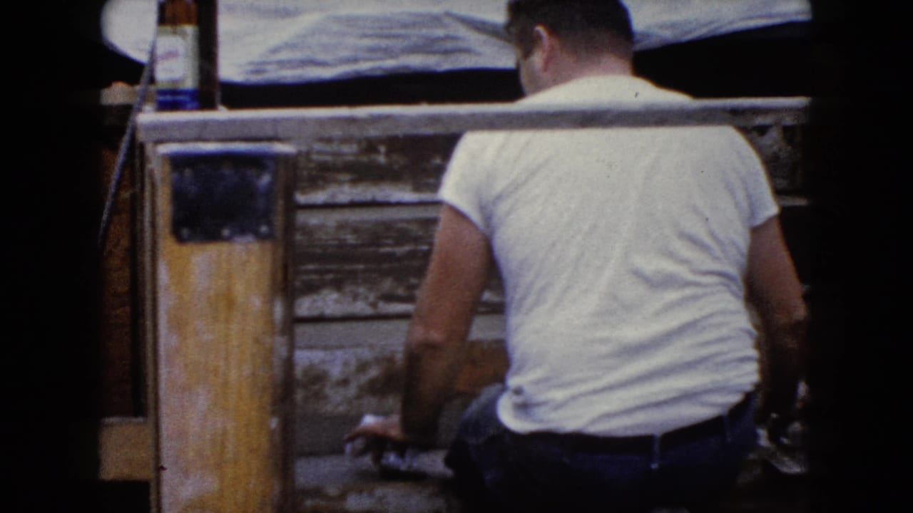 The final frame shows the man from behind near the wooden steps and post, continuing the outdoor repair work in Wauconda around 1960.