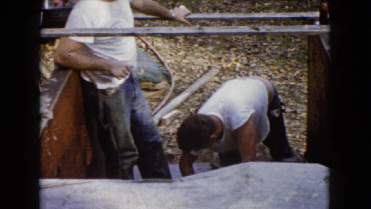 Near the end of the clip, two men remain by the Wauconda concrete forms as one bends over the newly finished step surface.