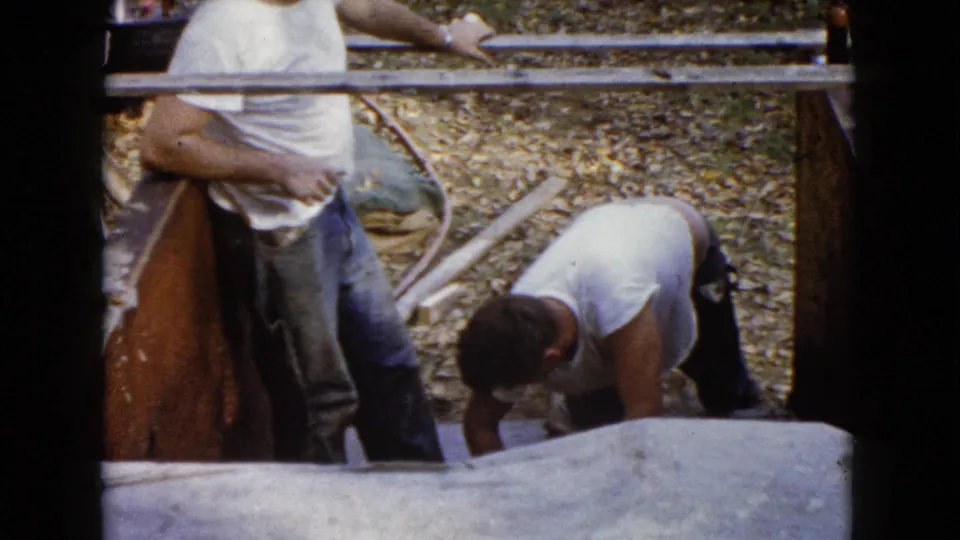 Near the end of the clip, two men remain by the Wauconda concrete forms as one bends over the newly finished step surface.