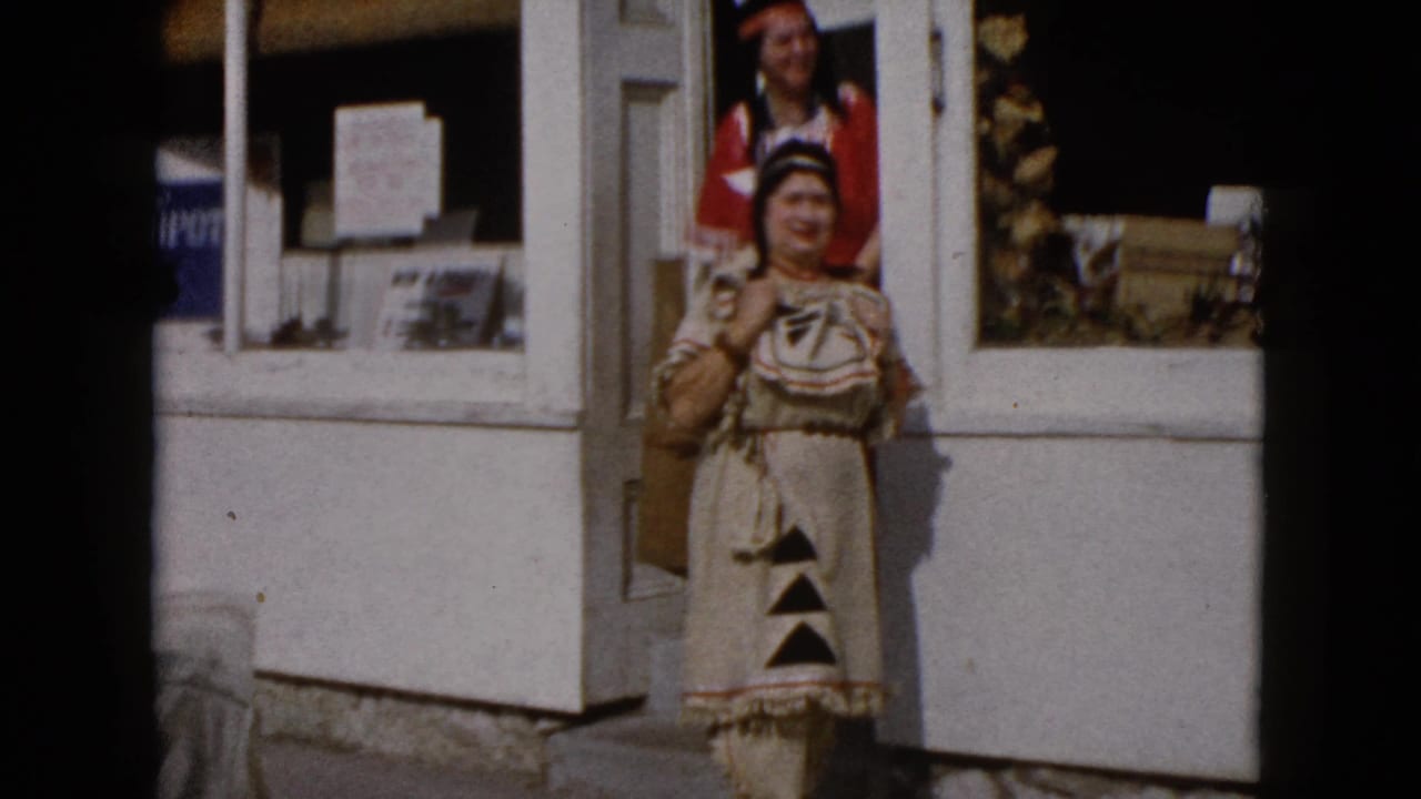 A woman in beige Native American-inspired attire stands outside the Wauconda storefront as another woman appears behind her.