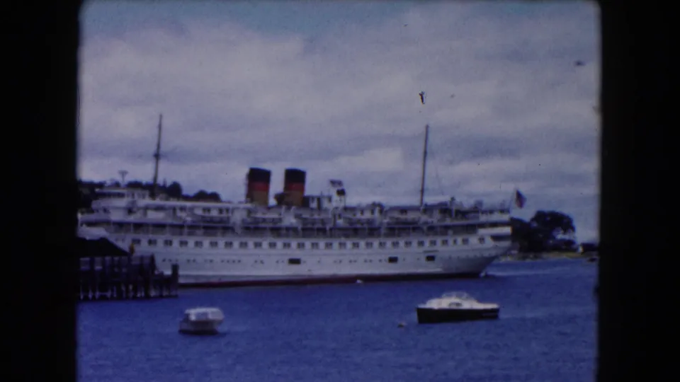 The final frame shows the large white ship still docked along the Buffalo waterfront, with two small boats in the foreground water.