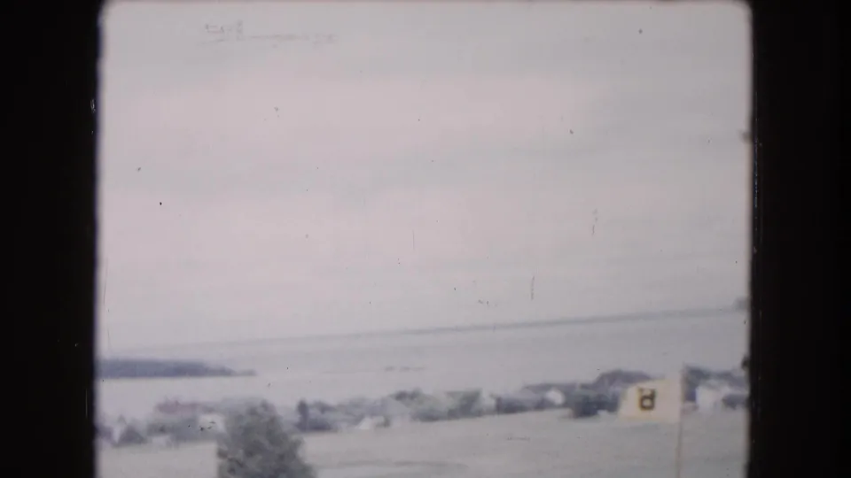 1961 Buffalo-area waterfront scene with distant water and shore, plus a foreground flag marked 3 near the right edge.