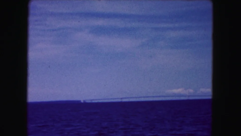 1961 Buffalo, New York 8mm still with a slightly tilted view of water and sky, with the distant bridge running along the horizon.