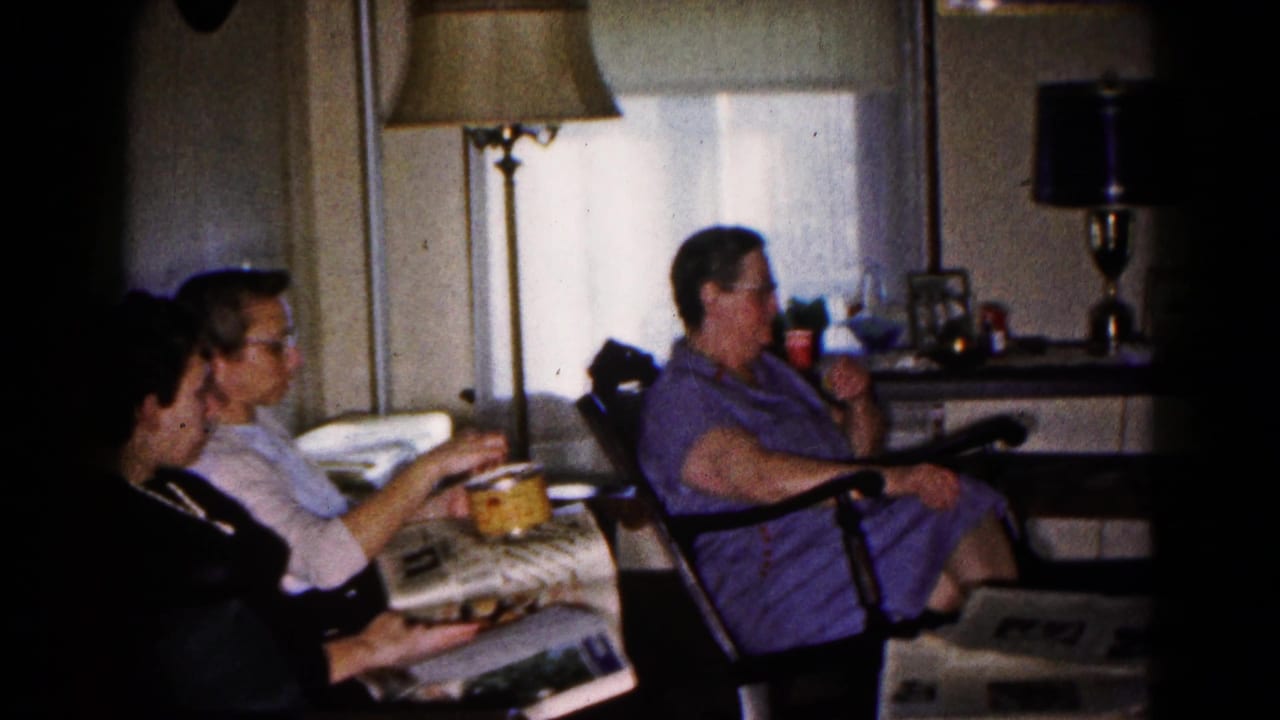 Adults in a Hagerstown living room appear to read and snack while seated near curtained windows, side tables, and period lamps.