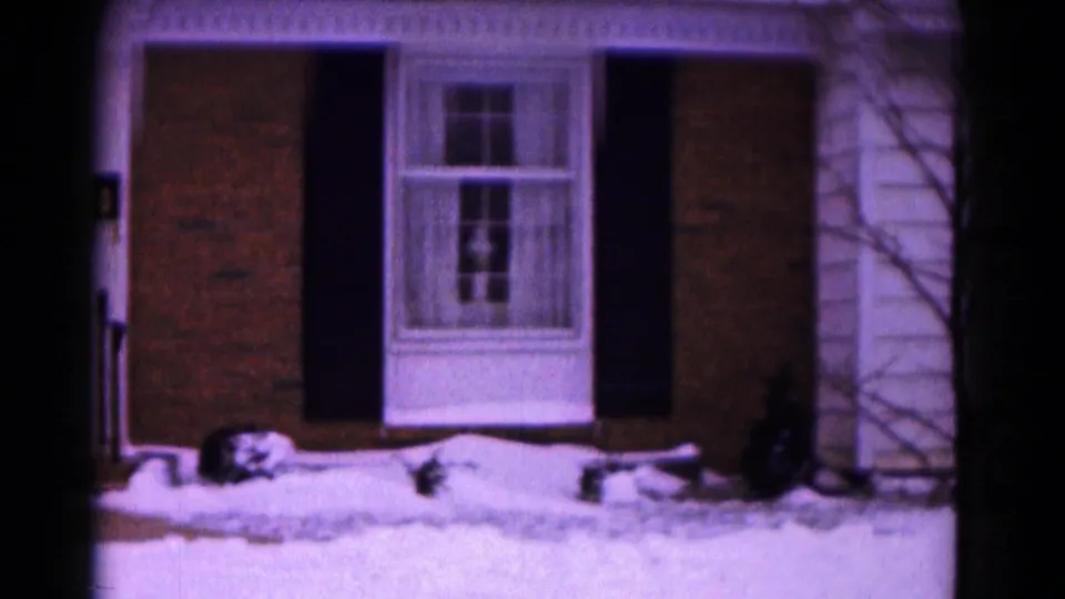 A later frame shows more of the house facade in Hagerstown, including a curtained window, dark shutters, snow at the foundation, and a bare tree.