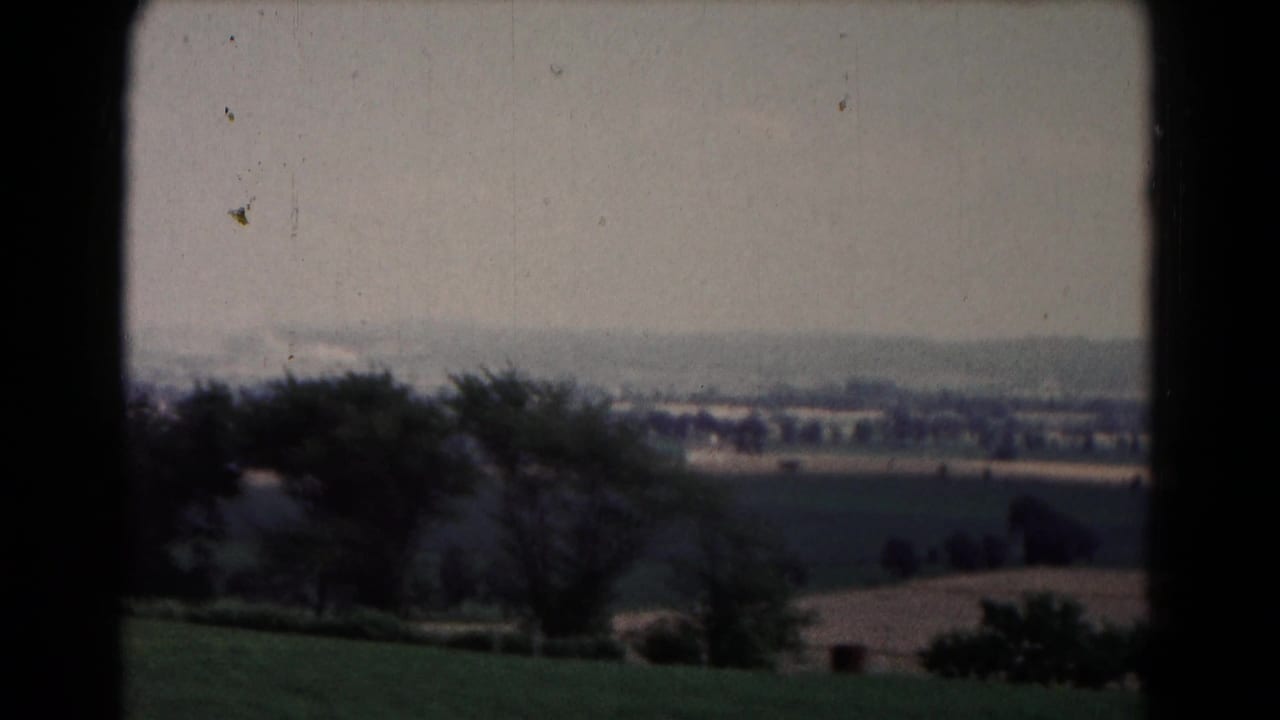 End of the 1961 Hagerstown-area pan, with trees, agricultural fields, distant buildings, and a low roof at the lower right edge.