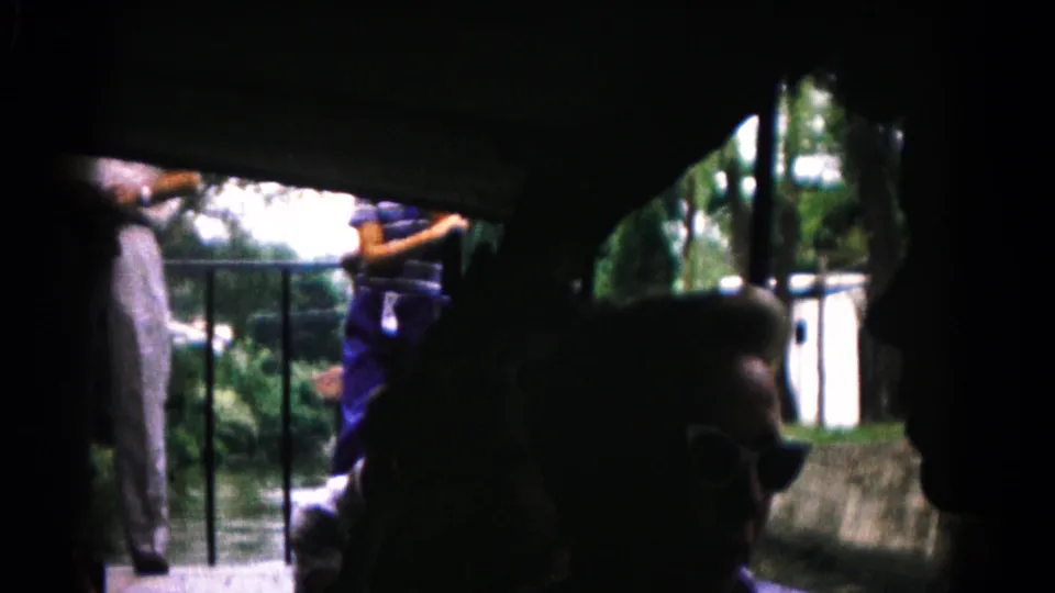 A 1961 Maryland river-tour view from inside the boat shows silhouetted passengers and standing figures outside near a railing.