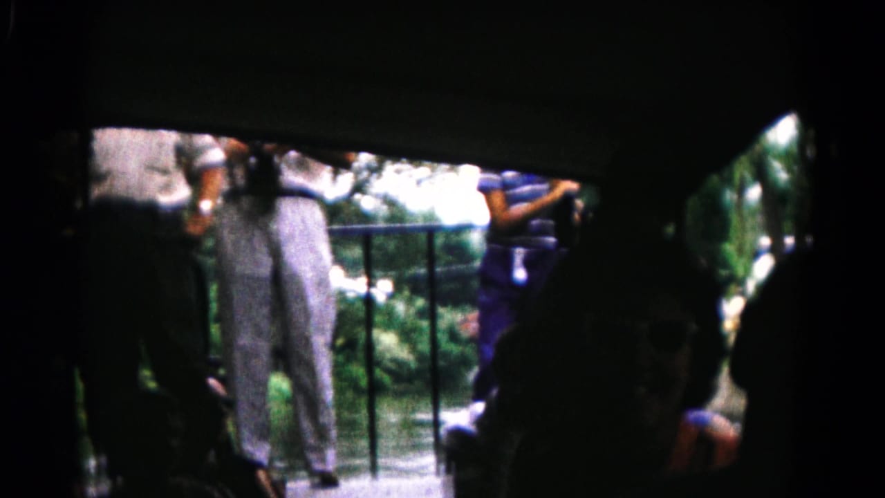 The 1961 Hagerstown-area home movie shows passengers in shadow looking out from a boat toward a riverside platform.