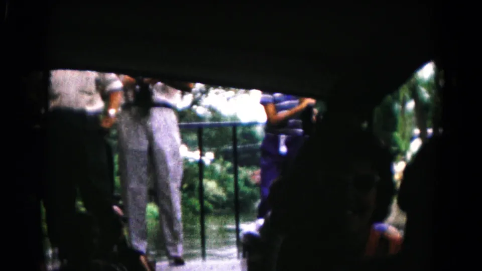 The 1961 Hagerstown-area home movie shows passengers in shadow looking out from a boat toward a riverside platform.