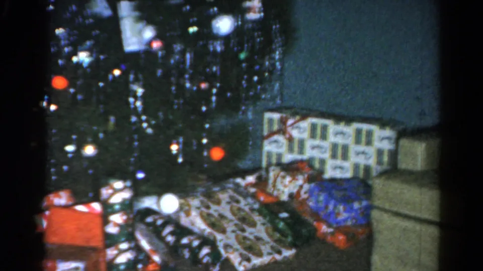 1962 Catskill Christmas interior showing tree ornaments, wrapped gifts, and part of the surrounding room.
