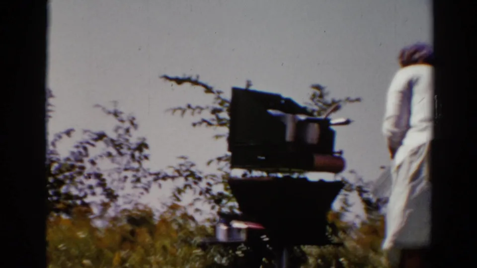The closing frame shows a backyard grill with pots in the foreground while the woman in light clothing leaves the edge of the 1962 Catskill shot.