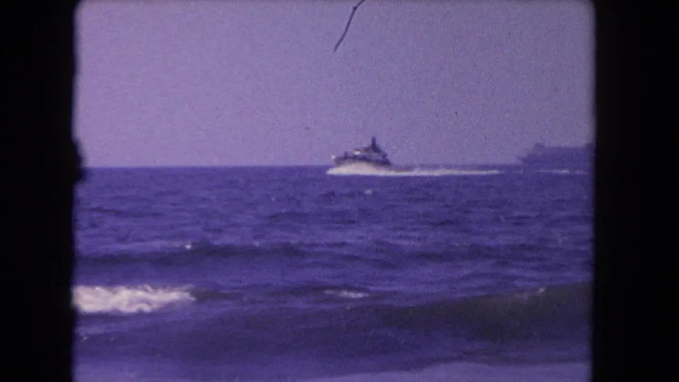 1962 Los Angeles-area 8mm frame showing a small motorboat moving across offshore waves.