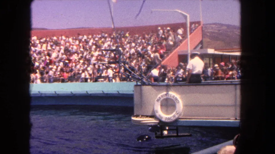 1962 Los Angeles-area marine attraction view with spectators, a show boat, and a visible Marineland of the Pacific life ring.