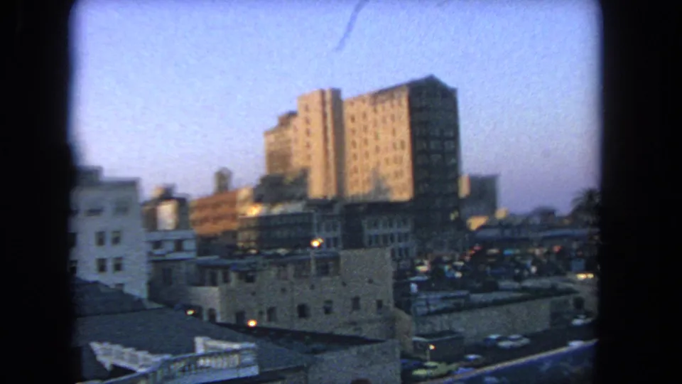 Elevated Los Angeles city view at dusk, filmed from a moving amusement ride in 1962.