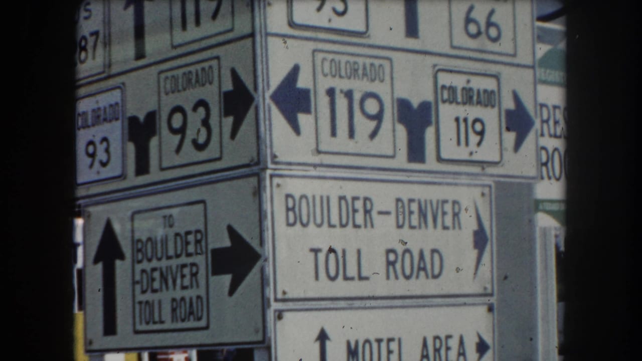 Close-up roadside signpost cluster showing Colorado routes 93, 119, US 287, Colorado 66, and Boulder-Denver Toll Road directions, circa 1962 Summit County, Colorado.