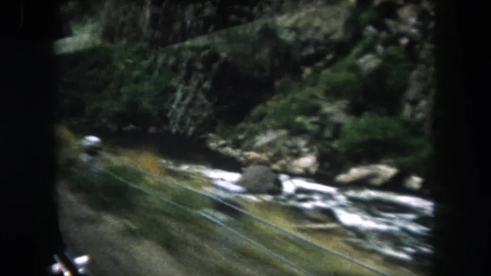 The final 1962 8mm frame shows the river continuing through a wooded Colorado canyon, with window reflections and car-frame shadows visible.