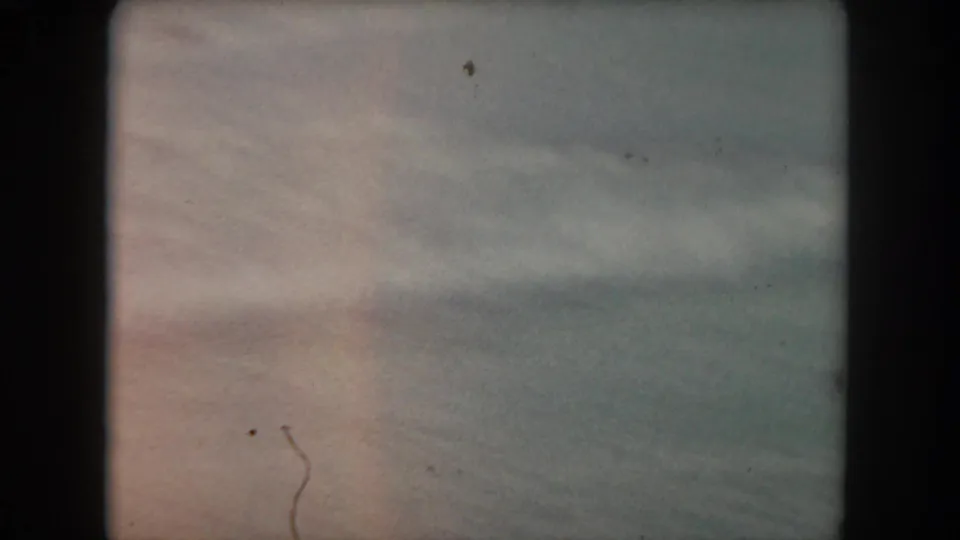 Soft, motion-blurred 8mm frame from the pan across a rural Colorado pasture.