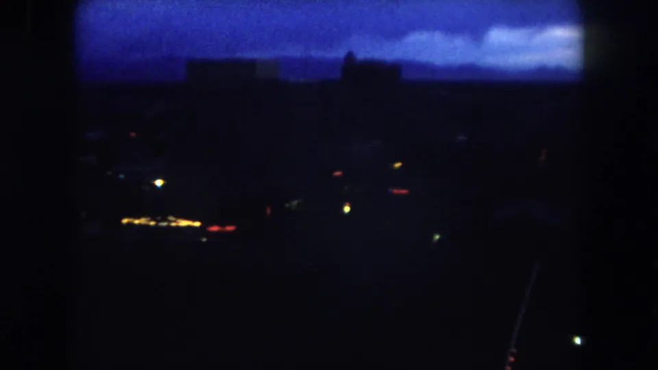 Final 1962 Summit County frame showing scattered night lights against a dark foreground and blue twilight horizon.
