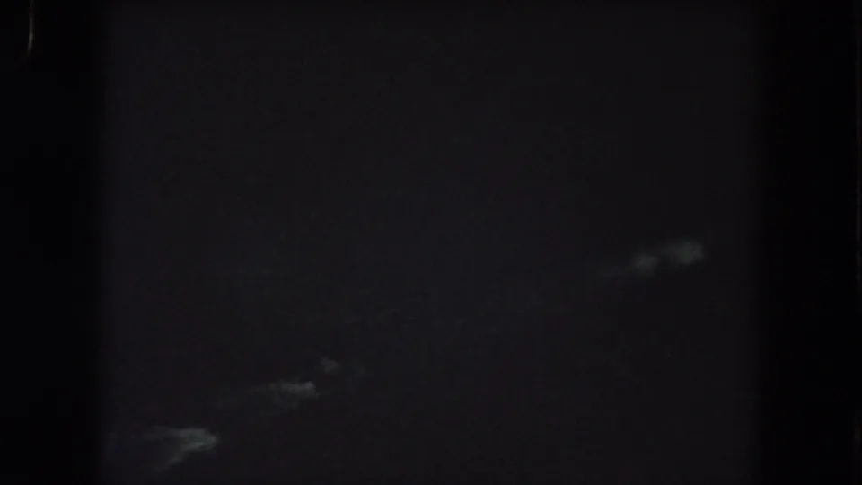 Dark Summit County 8mm frame with vague pale streaks in the upper field and little identifiable detail.