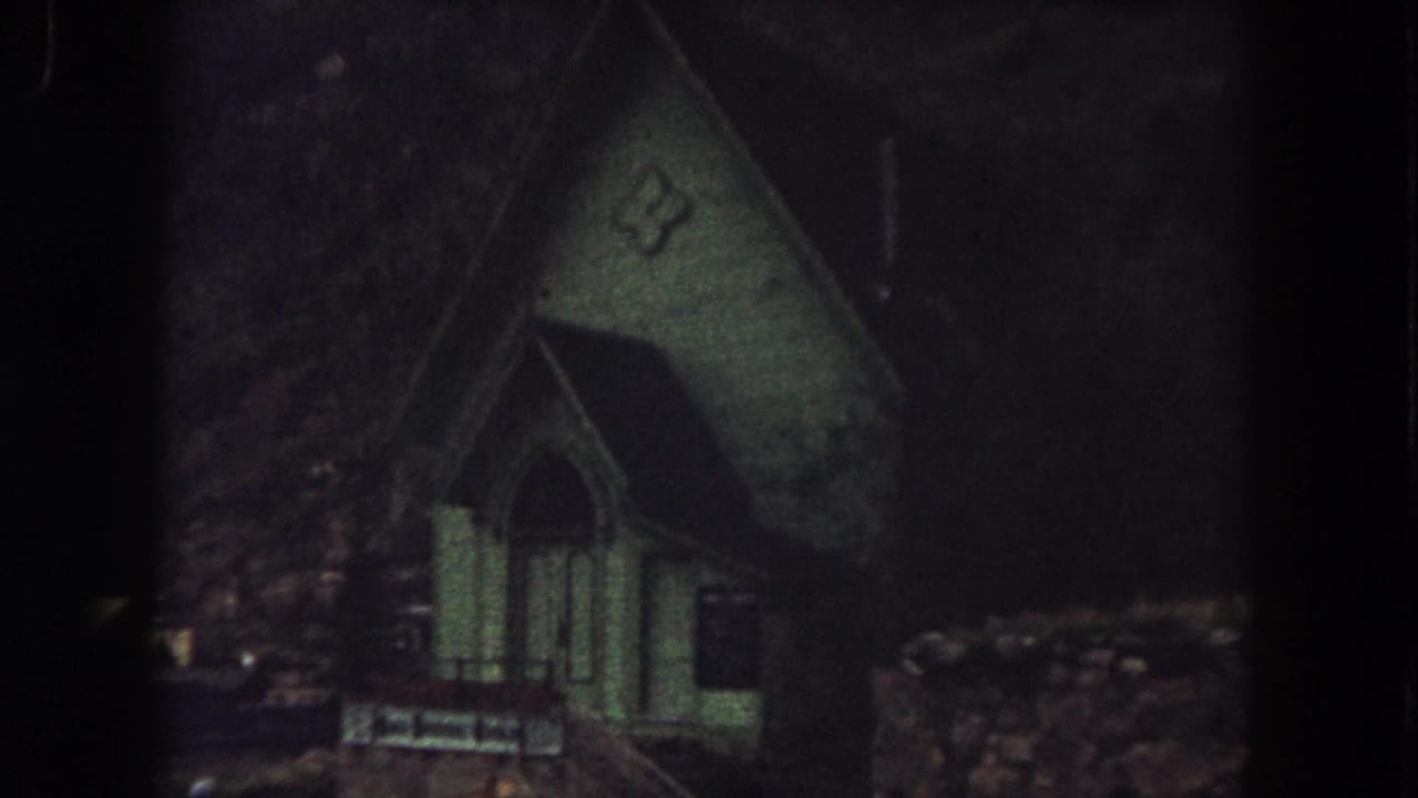 1962 Summit County, Colorado frame showing the small green church exterior in low light near the end of the clip.