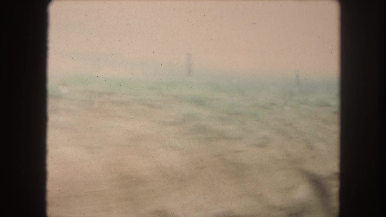 Soft, indistinct 1962 8mm train-window view of a hazy rural landscape likely near Winter Park, Colorado.