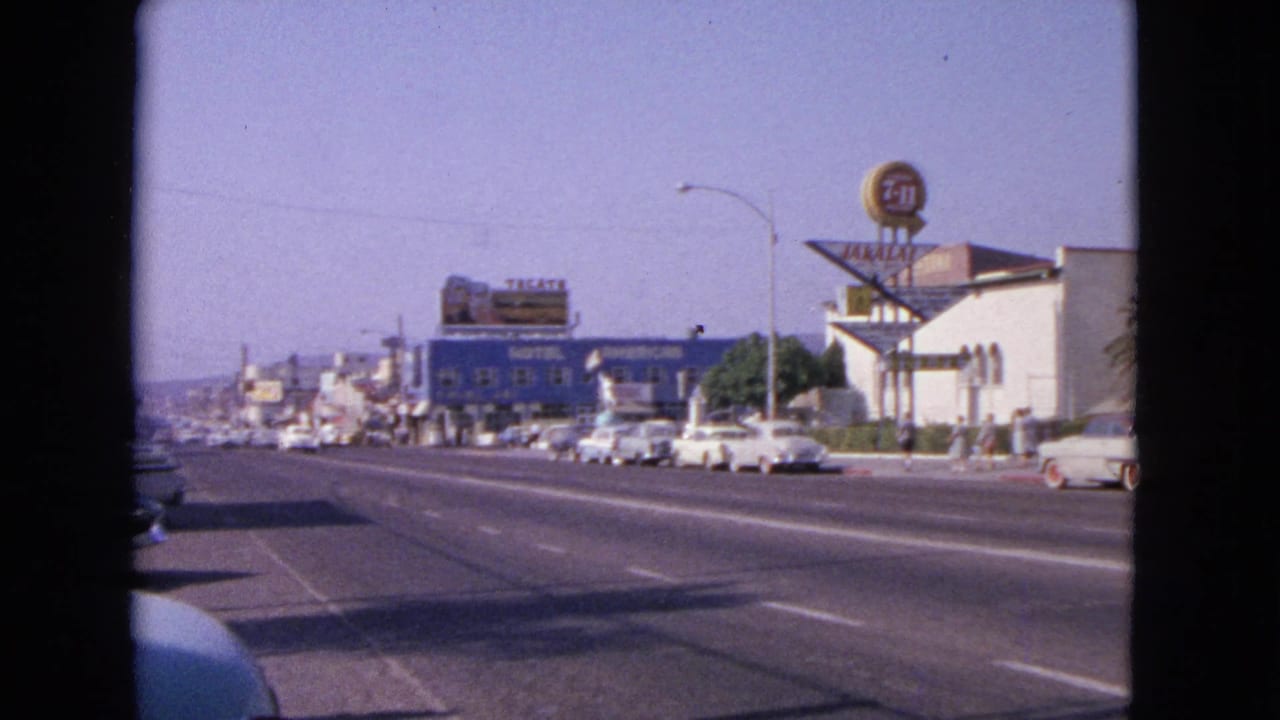 1963 Barrington, Illinois street view with early-1960s cars, motel frontage, billboards, and roadside commercial signage.