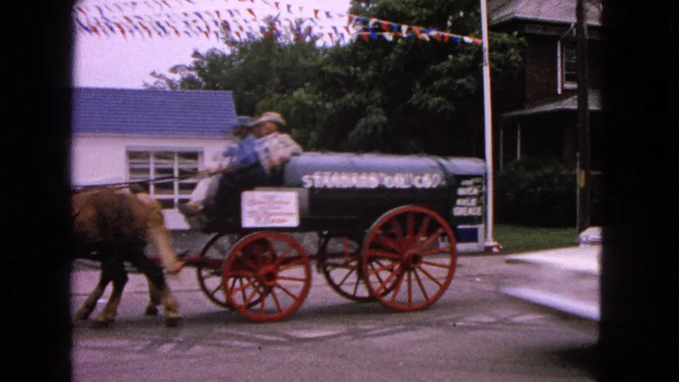 A closer 1963 Barrington view shows the branded tanker wagon, riders, red wheels, and nearby residential buildings.