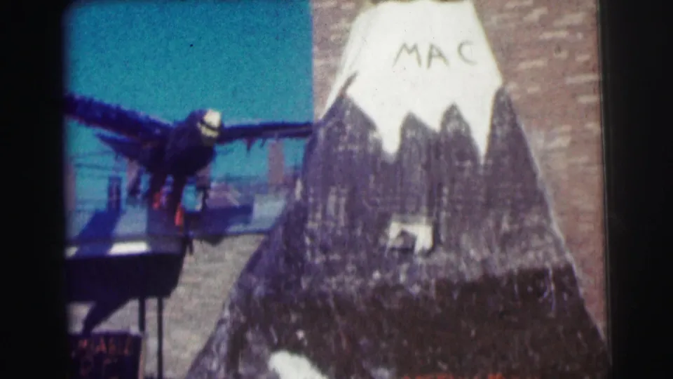 1963 Bowling Green University frame with the MAC-marked mountain display centered and the dark bird decoration partly at left.