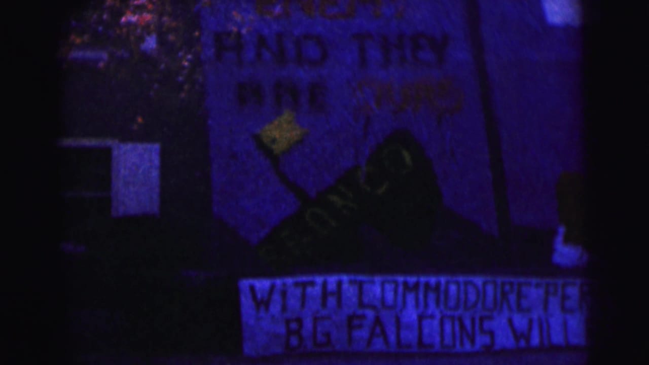 Blue-tinted banner with painted shoe graphic and partially visible text at night.
