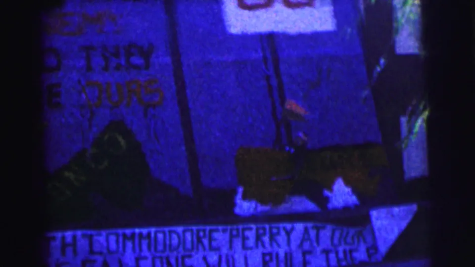 Final 1963 Bowling Green University frame shows a close, low-light view of handmade spirit signage with partial Commodore Perry and B.G. Falcons wording.