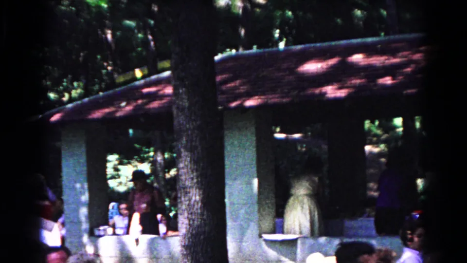 People gather beside the pavilion counter in a wooded Cold Springs park scene from 1963.