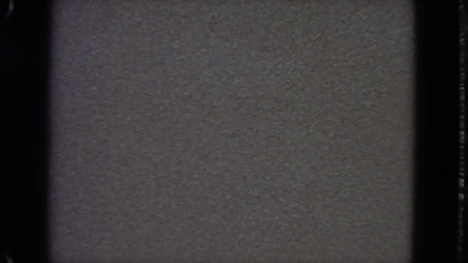 Late 8mm frame with a partial airplane-window sky view at the top and gray leader-like film area filling most of the frame.