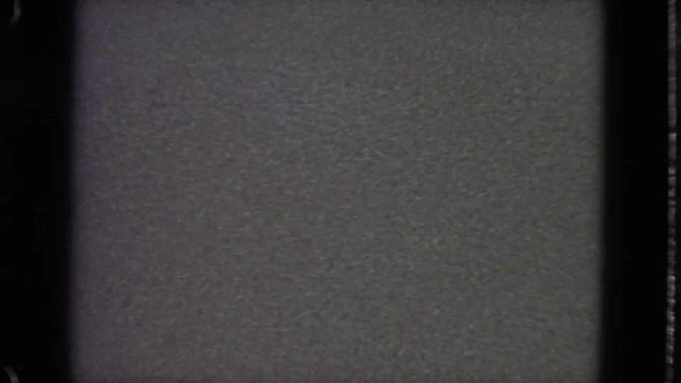 Final 8mm frame dominated by gray leader-like film texture, with a remaining strip of high-altitude clouds and sky above.