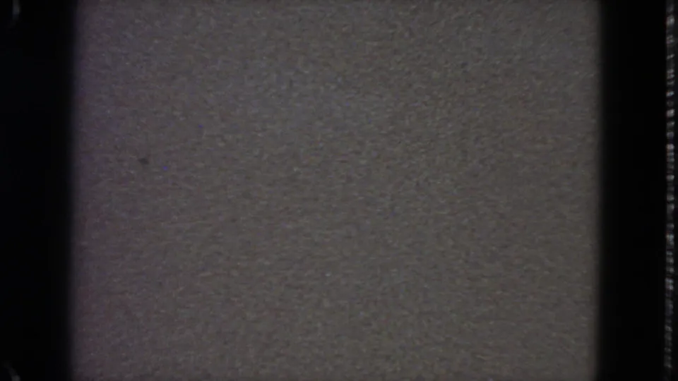 1963 8mm frame from San Francisco showing a grainy gray static-like field bordered by dark film edges.