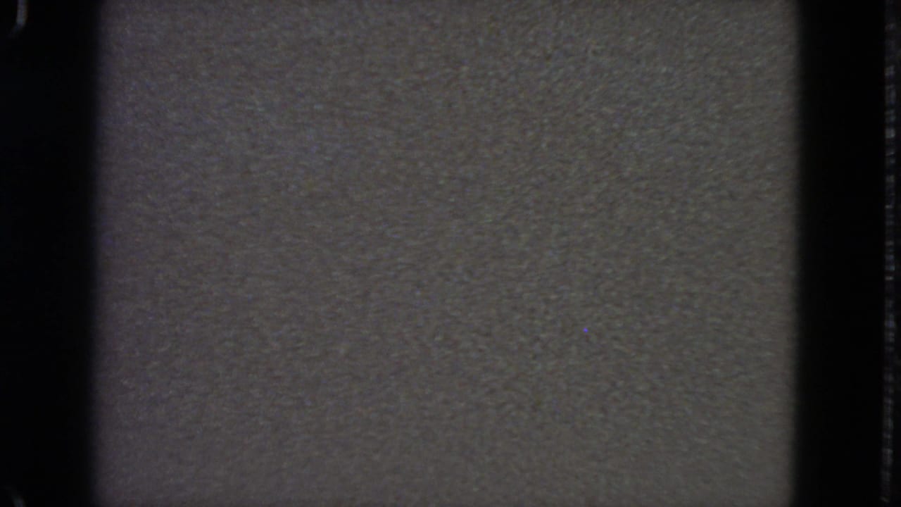 1963 8mm home-movie frame from San Francisco metadata, mostly dark and underexposed with visible gate edges and grain.