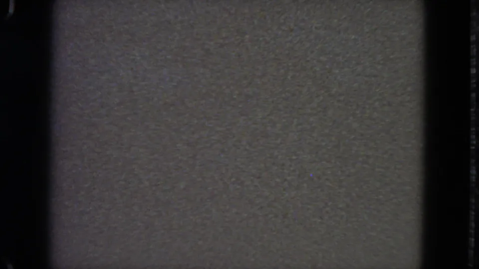 1963 8mm home-movie frame from San Francisco metadata, mostly dark and underexposed with visible gate edges and grain.