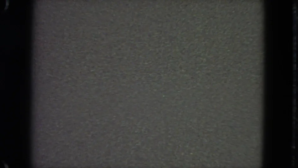 1963 San Francisco 8mm home-movie blank frame with visible grain, dark borders, and faint exposure variation.