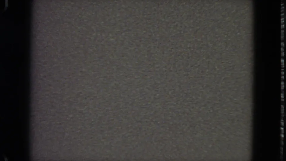 1963 San Francisco 8mm blank exposure with heavy grain, black frame edges, and no identifiable subject.