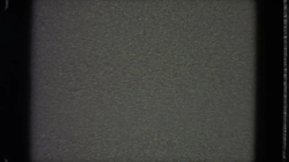 1963 San Francisco 8mm blank frame with visible grain, specks, and thick black gate borders.