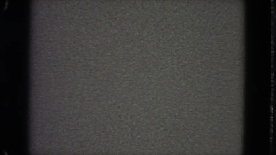 1963 8mm frame from a San Francisco reel showing a blank pale field, dark film borders, and visible grain texture.
