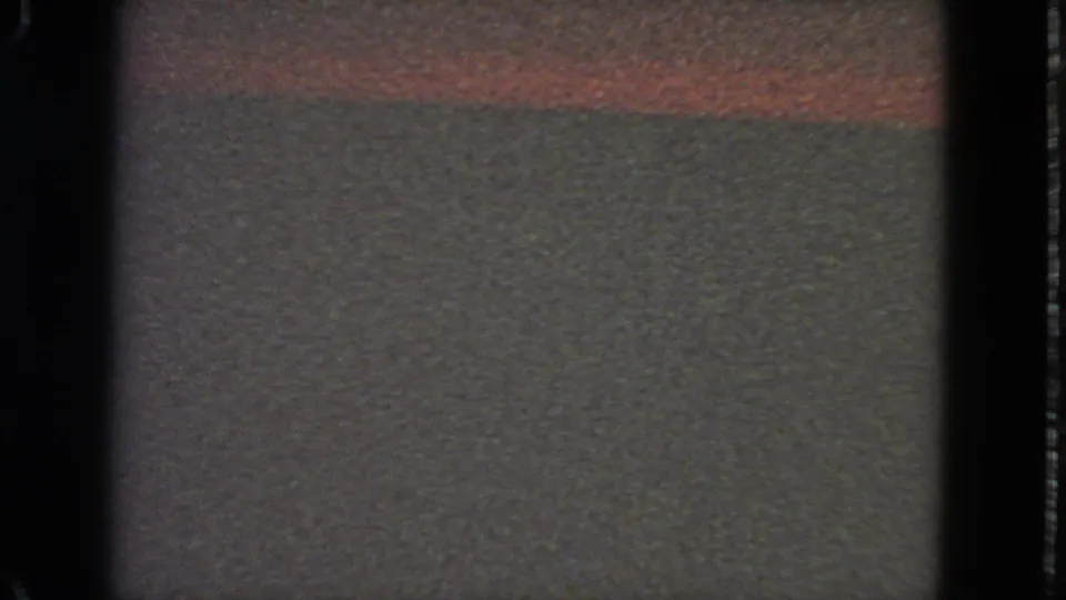 1963 8mm San Francisco reel frame with blank film texture, a red horizontal streak, and a faint bluish flash near the center.