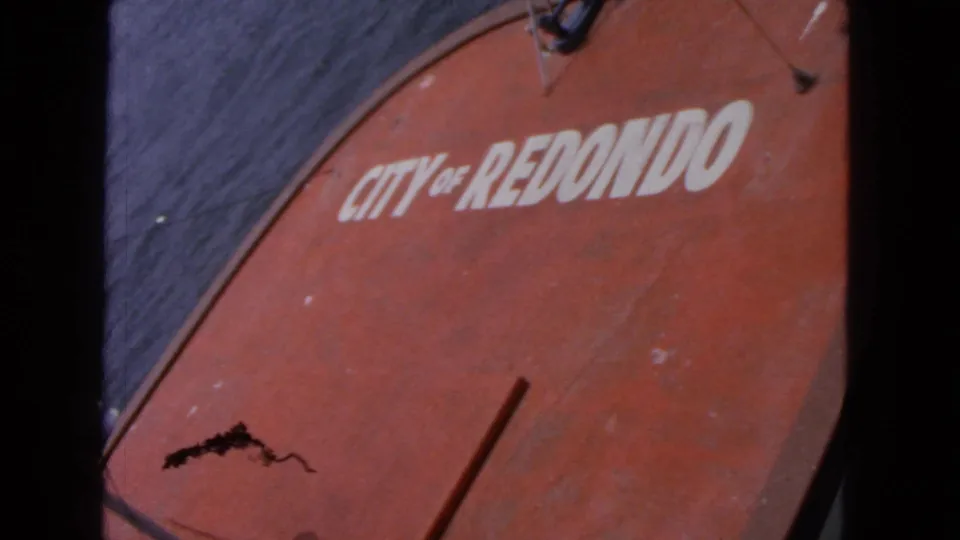 A second close view of the red City of Redondo marking on a boat, with open water visible along the top edge.