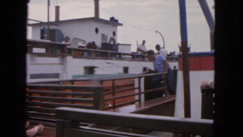 1963 San Francisco boating scene with adults leaning on railings, a white cabin boat, and close vessel spacing visible.