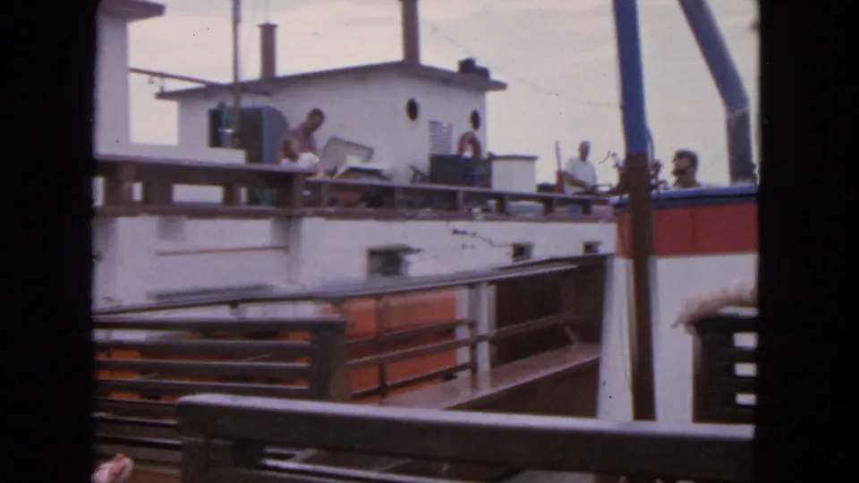 Final frame of the 1963 San Francisco boat scene, with passengers visible on deck near a white cabin and red hull detail.