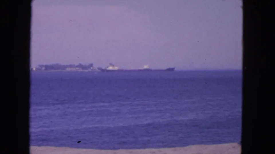 1963 San Francisco 8mm seascape showing distant ships across blue water with soft focus and dark frame borders.