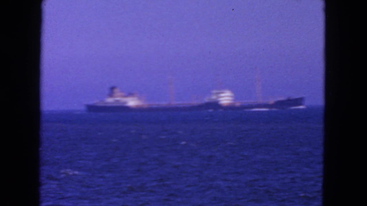 Ocean liner seen at a distance on a blue horizon.