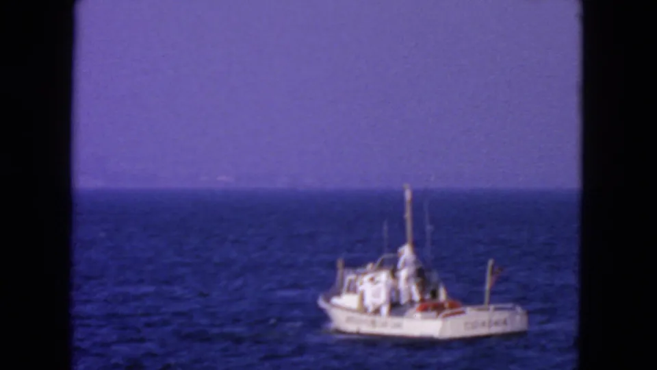 Side view of a marked white Coast Guard boat on open water in 1963 San Francisco-area footage.